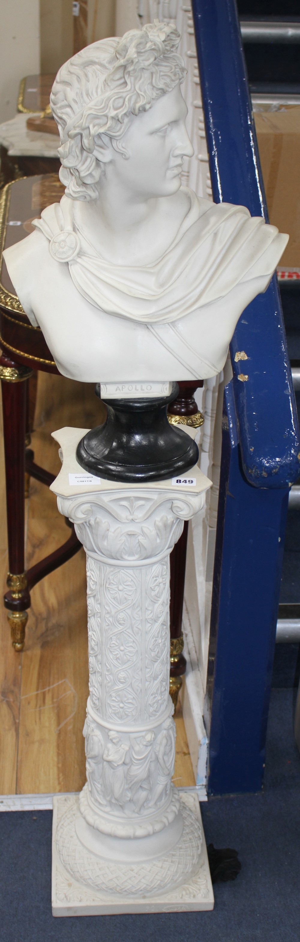 A composition faux marble bust of Apollo on a pedestal, overall H.128cm